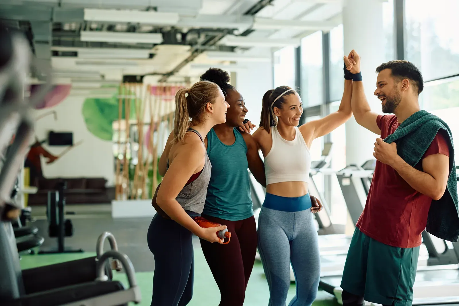 Small workout group celebrating together after finishing a training session
