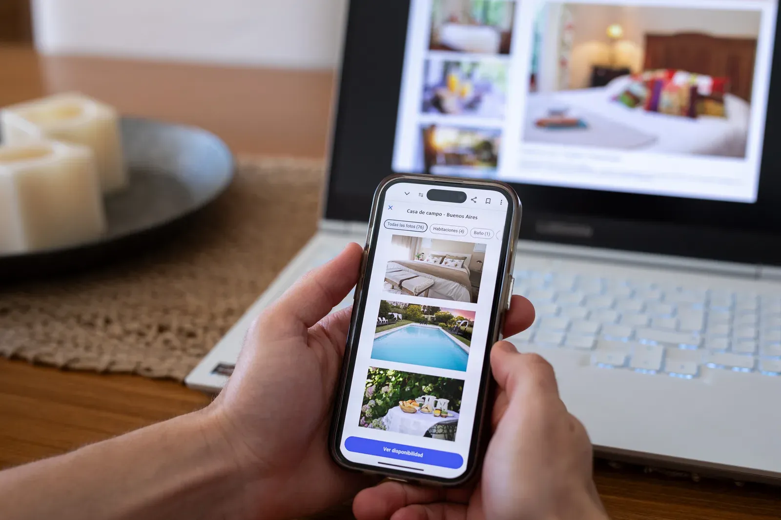 Person scrolling through online booking listings on a smartphone screen