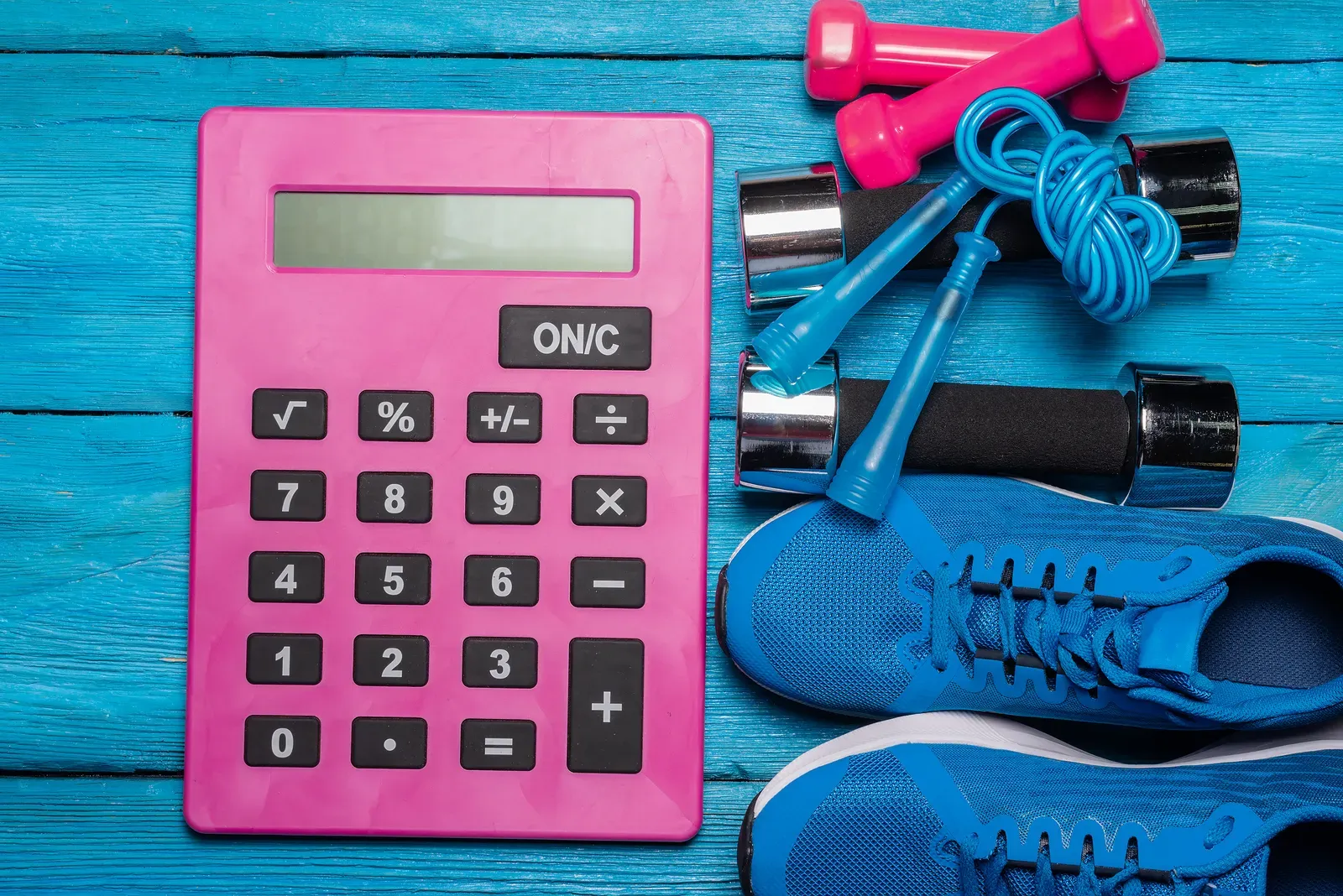 Working out hourly training costs with a notebook and calculator