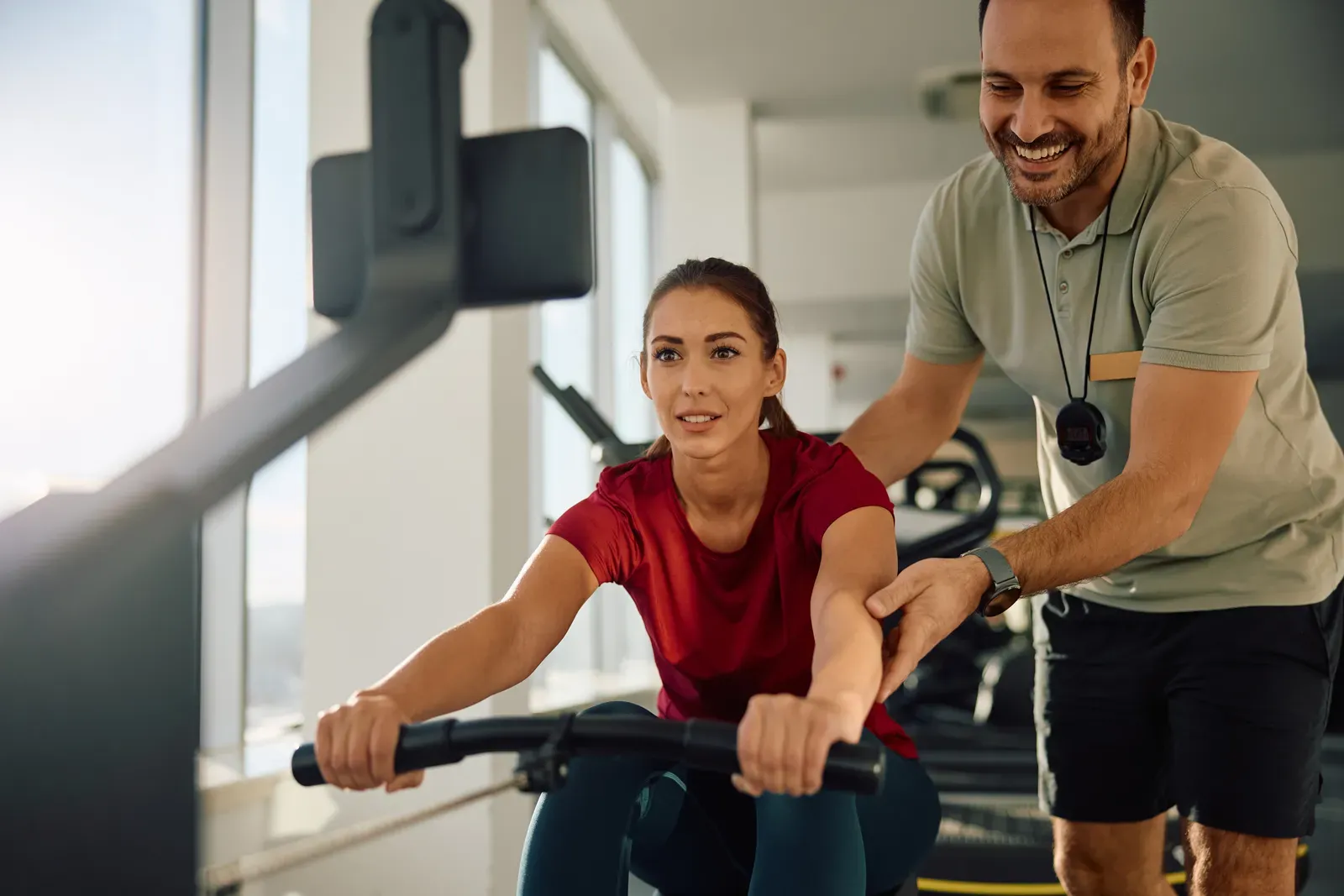 An athlete rowing hard through an interval on an indoor rowing machine