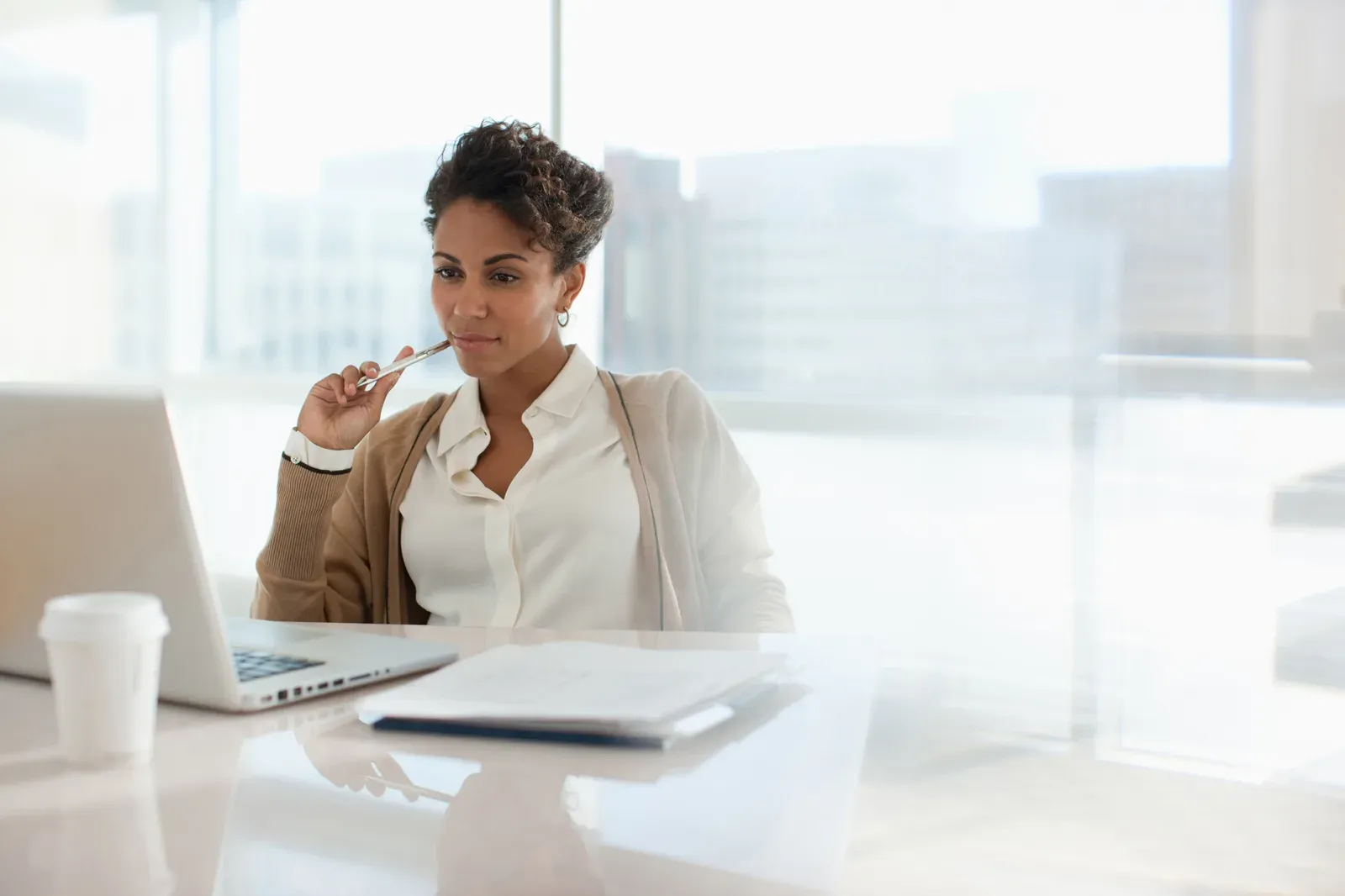 Businesswoman at her laptop sorting out how to pay herself from an LLC