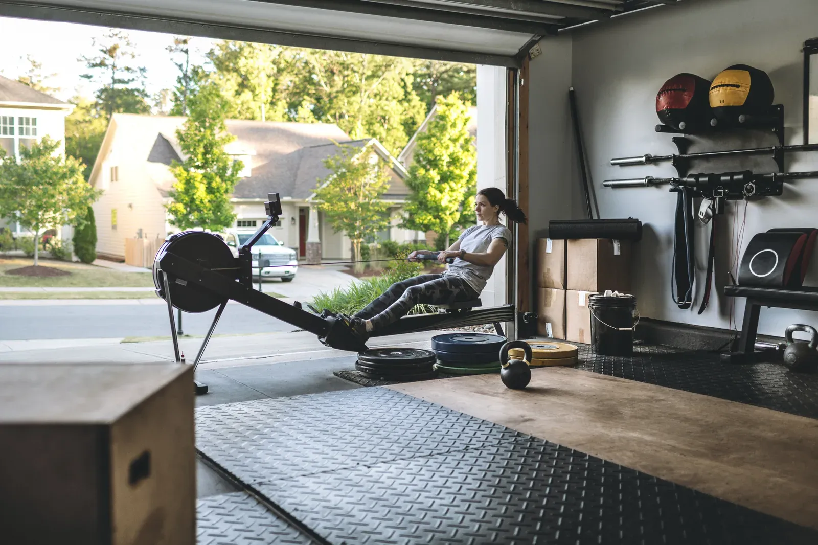 Rowing machine session underway in a home garage gym