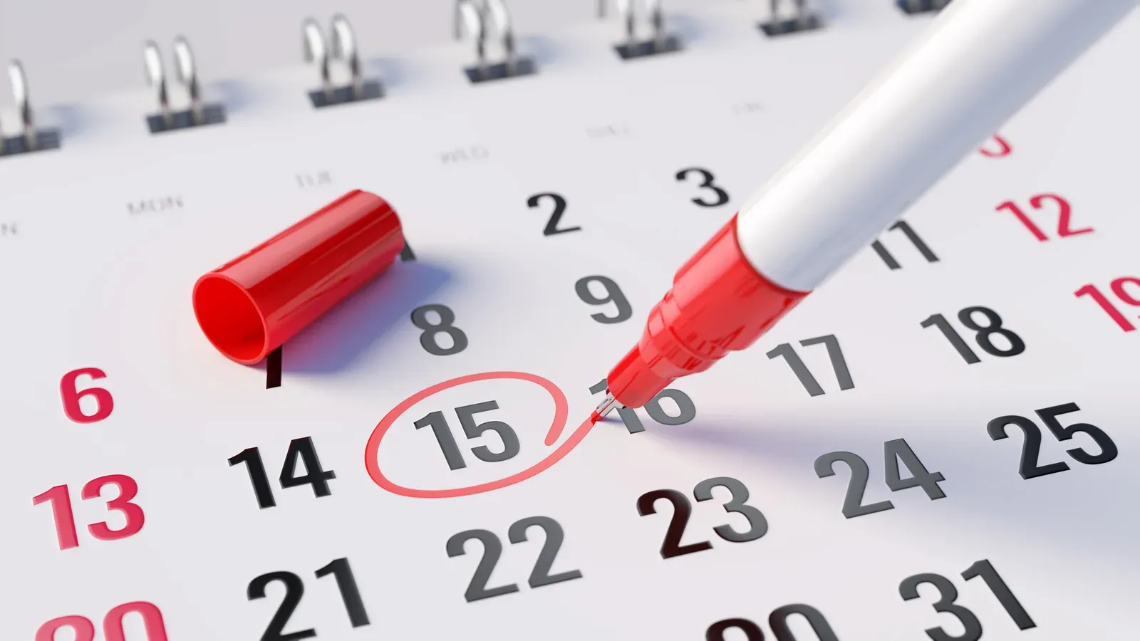 Marking an expiration date on a calendar with a red marker pen
