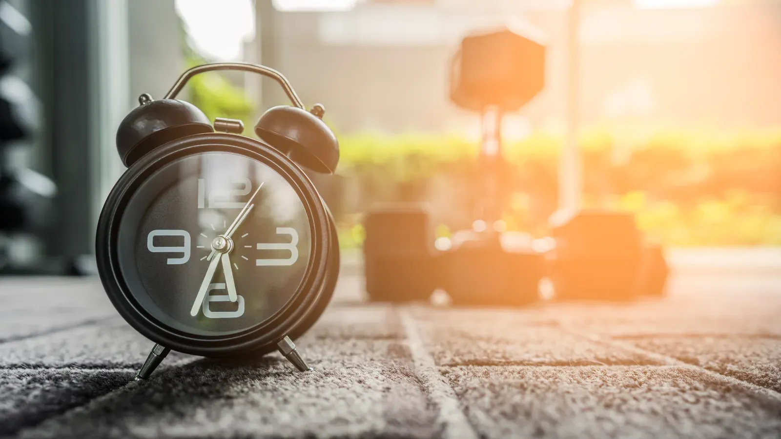 Alarm clock in a fitness room, keeping time on a trainer's working hours
