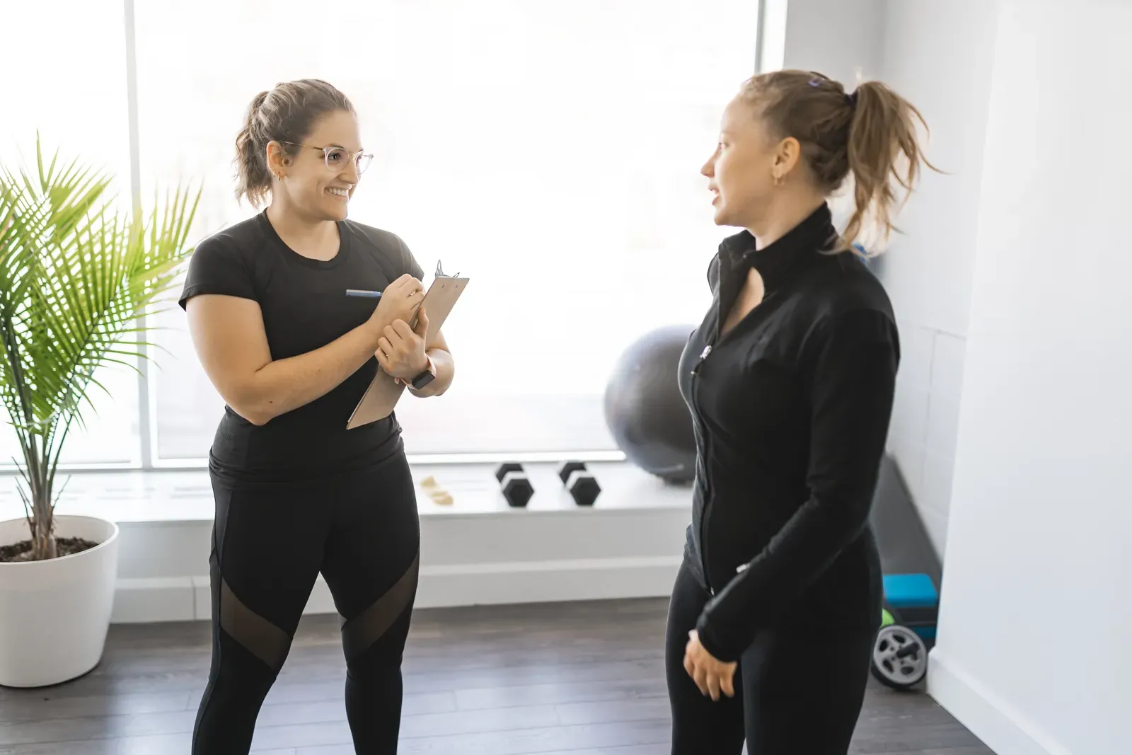 A trainer coaching a client through a one on one session