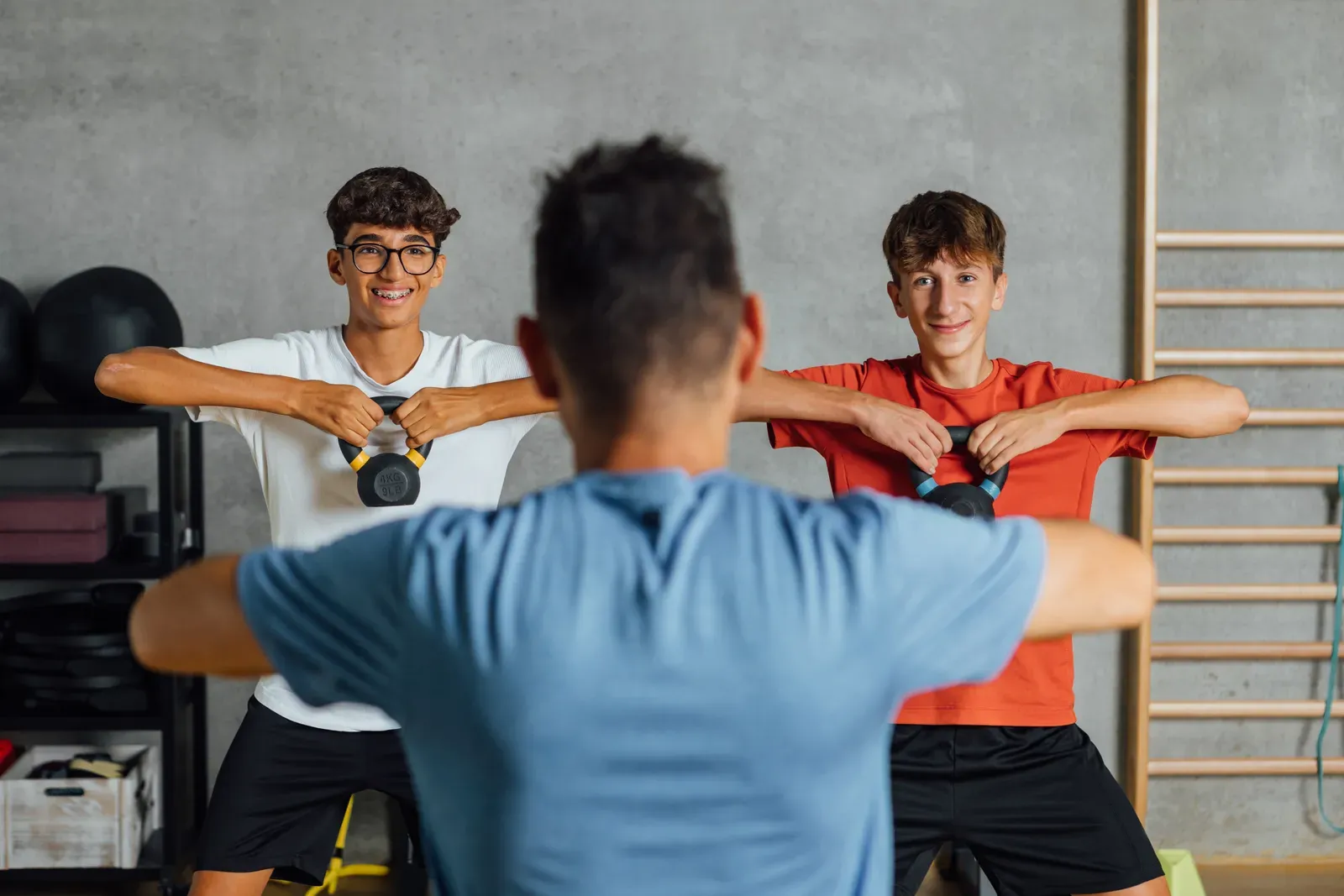 A coach guiding a client through a drill in a focused indoor session